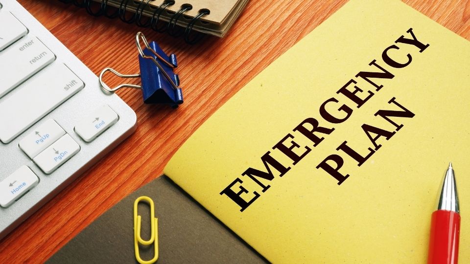 File with the words Emergency Plans on a desk